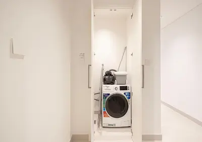 a washer and dryer in a white room at Lux Escape, Burj Crown Opera View, Near Dubai Mall in Dubai