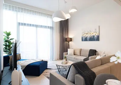 a living room with a couch and a tv at Lux Escape, Burj Crown Opera View, Near Dubai Mall in Dubai