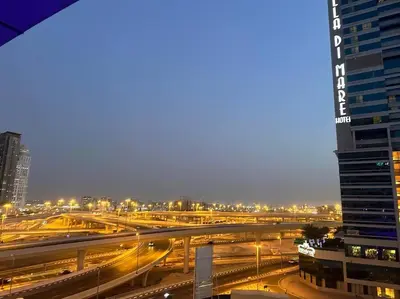 a view of a city with traffic at night at Beautiful Studio Apartment in Dubai