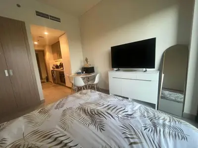 a bedroom with a bed with a flat screen tv at The Perfect Couples Nest in Dubai