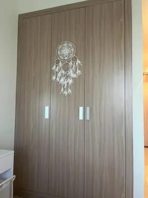 a large wooden cabinet with a chandelier on it at The Perfect Couples Nest in Dubai