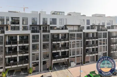 an apartment building with a sign in front of it at Cozy Modern Studio Oxford Residence in Dubai