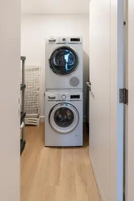 a washing machine and a washer and dryer in a room at Al Andalus Tower F, Cadiz JGE - 3BR Apartment - Allsopp & Allsopp in Dubai