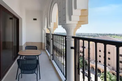 a balcony with a table and chairs and a view at Al Andalus Tower F, Cadiz JGE - 3BR Apartment - Allsopp & Allsopp in Dubai