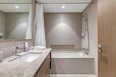 a bathroom with a large tub and a sink at Knokey Luxury 1BR Apartments - 5 min walk to Burj Khalifa & Dubai Mall & Dubai Fountain in Dubai