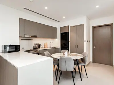a kitchen and dining room with a table and chairs at Knokey Luxury 1BR Apartments - 5 min walk to Burj Khalifa & Dubai Mall & Dubai Fountain in Dubai