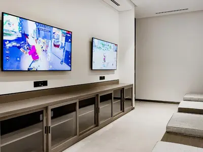 a living room with a large flat screen tv on a wall at Knokey Luxury 1BR Apartments - 5 min walk to Burj Khalifa & Dubai Mall & Dubai Fountain in Dubai
