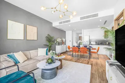 a living room with a couch and a table at EDEN'S Homes & Villas - VIDA Dubai Marina Residences in Dubai