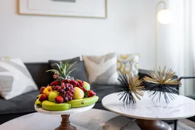 a plate of fruit on a table in a living room at EDEN'S Homes & Villas - VIDA Dubai Marina Residences in Dubai