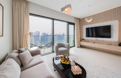 a living room with a couch and a tv at EDEN'S Homes & Villas - VIDA Dubai Marina Residences in Dubai