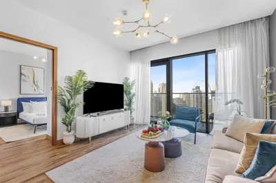 a living room with a couch and a tv at EDEN'S Homes & Villas - VIDA Dubai Marina Residences in Dubai