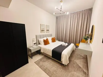 a bedroom with a large bed and a window at Comfy 1br In Al Jaddaf Balcony Parking in Dubai