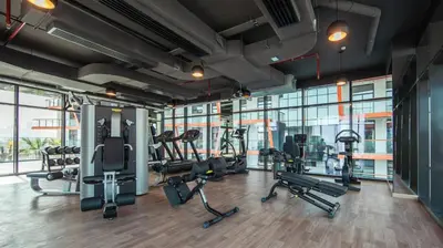 a gym with treadmills and ellipticals in a building at Comfy 1br In Al Jaddaf Balcony Parking in Dubai