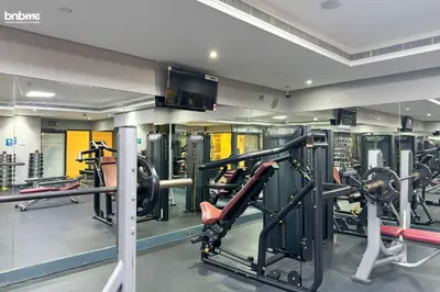 a gym with several treadmills and machines at bnbme - Stylish JLT Studio Near Metro Rooftop Pool Gym Balcony Marina Access in Dubai