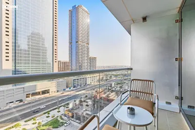 a balcony with a table and a view of a city at bnbme - Stylish JLT Studio Near Metro Rooftop Pool Gym Balcony Marina Access in Dubai