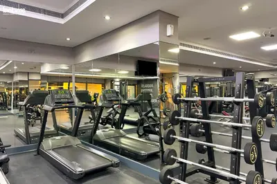 a gym with several tread machines in a room at bnbme - Stylish JLT Studio Near Metro Rooftop Pool Gym Balcony Marina Access in Dubai