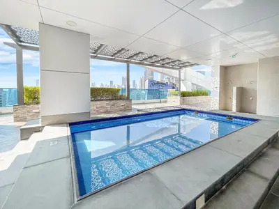 an indoor swimming pool with a view of the city at Nicely Furnished Home in the Heart of Business Bay in Dubai