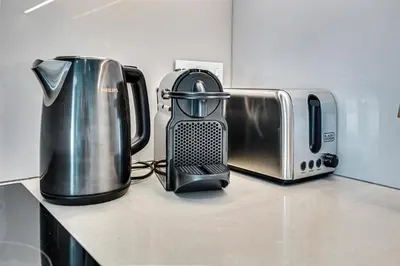 a kitchen counter with a toaster and a toaster and a coffee maker at Stylish 1BR apartment in Address Beach Residence in Dubai