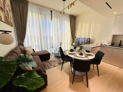 a living room with a couch and a table at Sleek 1br In Jvc Free Parking Pool & Balcony in Dubai