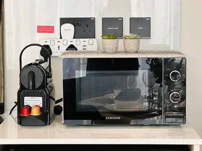 a microwave sitting on top of a counter at Sleek 1br In Jvc Free Parking Pool & Balcony in Dubai