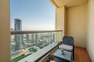 a balcony with a chair and a view of the city at GuestReady - Beachfront delight in JBR in Dubai