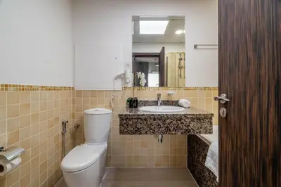 a bathroom with a toilet and a sink at GuestReady - Beachfront delight in JBR in Dubai