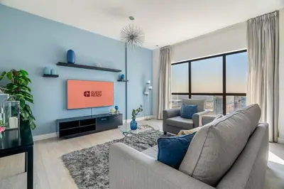 a living room with a couch and a tv at GuestReady - Contemporary stay in Dubai Marina in Dubai