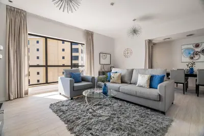a living room with a couch and a table at GuestReady - Contemporary stay in Dubai Marina in Dubai
