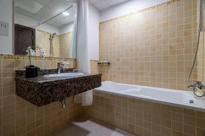 a bathroom with a sink and a bath tub at GuestReady - Contemporary stay in Dubai Marina in Dubai