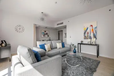 a living room with a couch and a table at GuestReady - Contemporary stay in Dubai Marina in Dubai