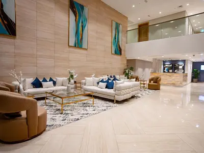 a lobby with couches and chairs and a table at Elgant 2 bedroom in Dubai