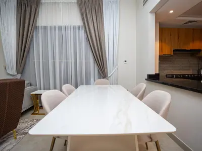 a white conference room with a white table and chairs at Elgant 2 bedroom in Dubai
