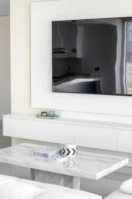 a living room with a mirror above a white table at Luxury Coastal Escape - Bright 3BR Apt - La Vie JBR in Dubai