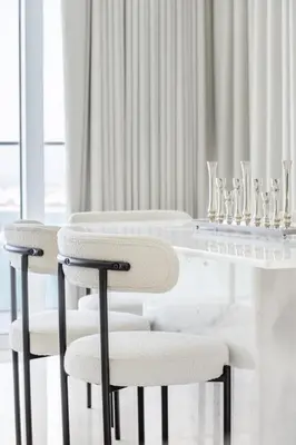 a white dining room with a white table and chairs at Luxury Coastal Escape - Bright 3BR Apt - La Vie JBR in Dubai