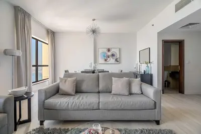 a living room with a couch and a table at GuestReady - Charming retreat in Dubai Marina in Dubai