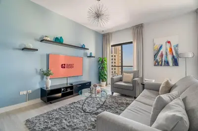 a living room with a couch and a tv at GuestReady - Charming retreat in Dubai Marina in Dubai