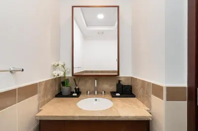 a bathroom with a sink and a mirror at Lux BnB I 29 Blvd I Burj Khalifa & Fountain Views in Dubai