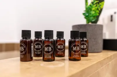 a group of four bottles of hot sauce on a counter at Lux BnB I 29 Blvd I Burj Khalifa & Fountain Views in Dubai