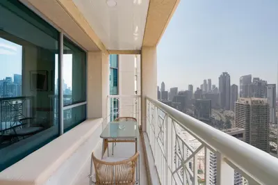 a balcony of a building with a table and chairs at Lux BnB I 29 Blvd I Burj Khalifa & Fountain Views in Dubai