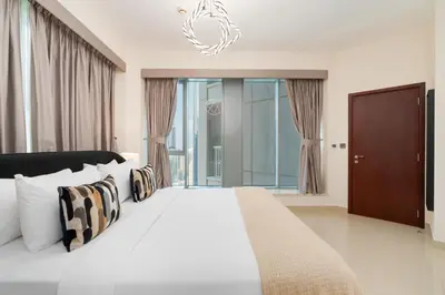 a bedroom with a large white bed with pillows at Lux BnB I 29 Blvd I Burj Khalifa & Fountain Views in Dubai