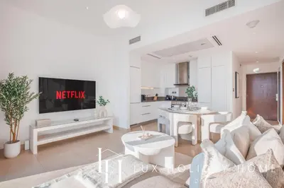 a living room with a couch and a tv at LUX The Marina Gate Sea View Suite 2 in Dubai