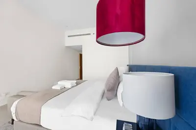 a bedroom with a bed and a red lamp at Spacious 1-Bedroom Apartment In Bay Square in Dubai