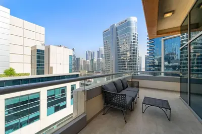 a balcony with a view of a city skyline at Spacious 1-Bedroom Apartment In Bay Square in Dubai