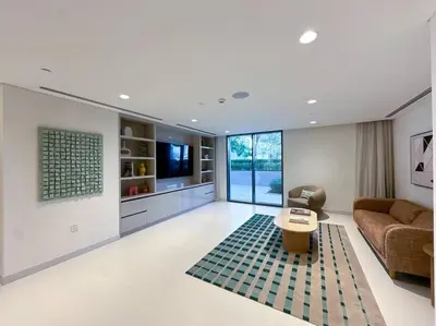 a living room with a couch and a table at Coastal Chic 1 Bedroom Apartment w private beach in Dubai