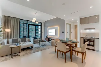 a living room with a couch and a table at Coastal Chic 1 Bedroom Apartment w private beach in Dubai