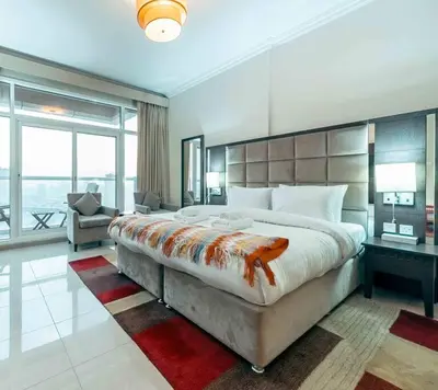 a large bedroom with a large bed and a couch at Comfortable Fully Furnished Studio l Ideal Living Space in Dubai