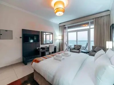 a hotel room with a large bed and a television at Comfortable Fully Furnished Studio l Ideal Living Space in Dubai