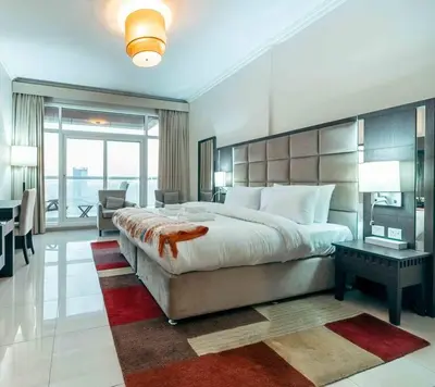 a large bedroom with a large bed and a desk at Comfortable Fully Furnished Studio l Ideal Living Space in Dubai