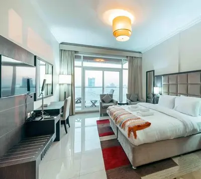 a large bedroom with a large bed and a desk at Comfortable Fully Furnished Studio l Ideal Living Space in Dubai