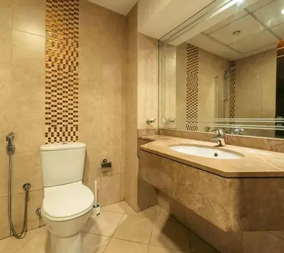 a bathroom with a toilet and a sink at Comfortable Fully Furnished Studio l Ideal Living Space in Dubai